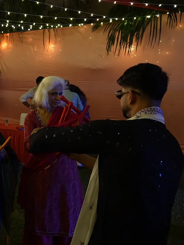 Ashish playing dandiya with an elder guest at Suncity Garba Ni Raat 2.0